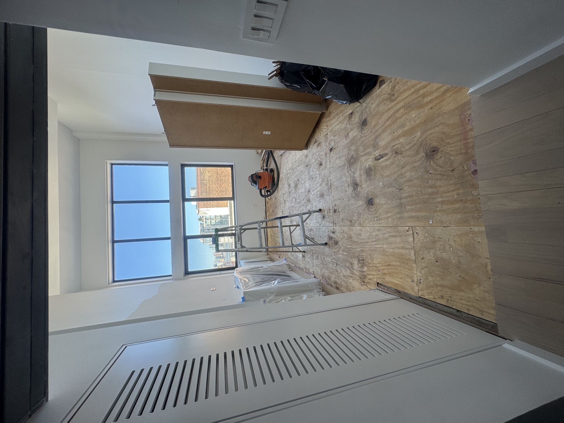 Gut-reno interior with plywood walls and dropped soffit framing