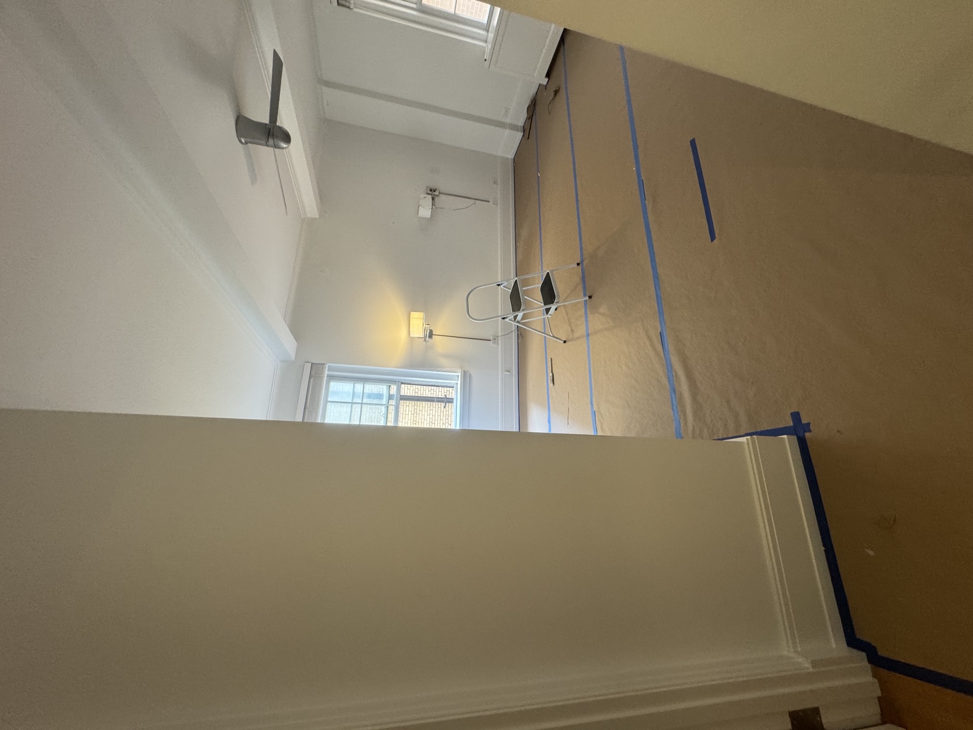 Freshly installed crown molding and baseboard detail in a stairwell