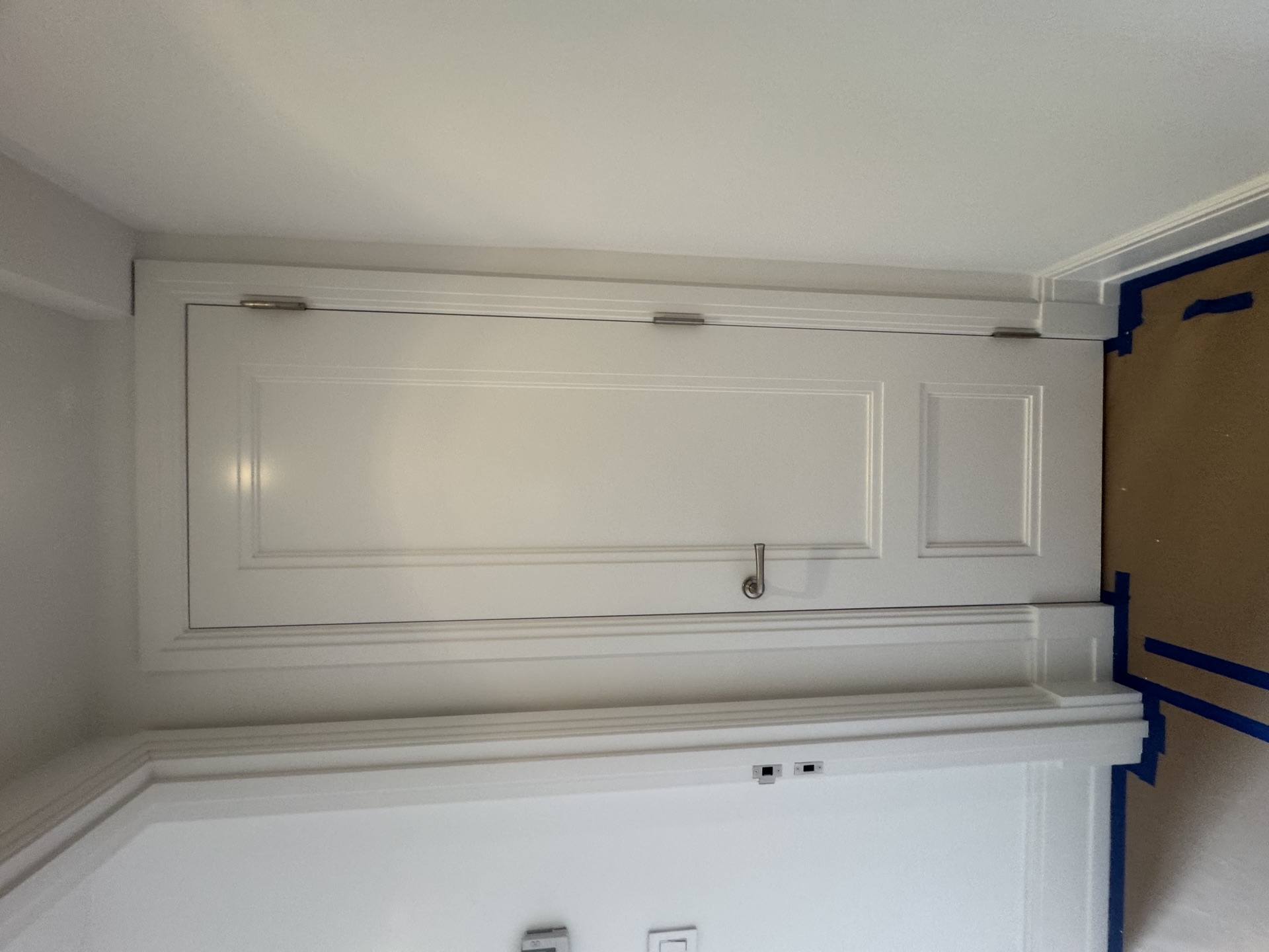 Custom built-in cabinet with paneled doors and detailed trim molding