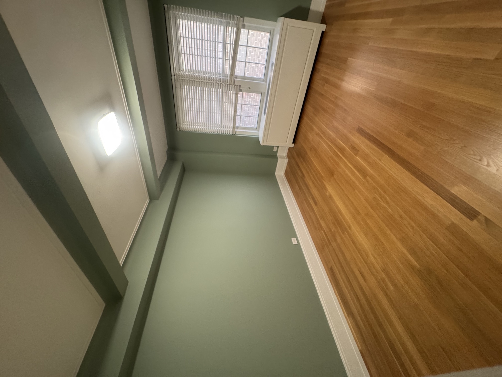 Sage green bedroom with white trim