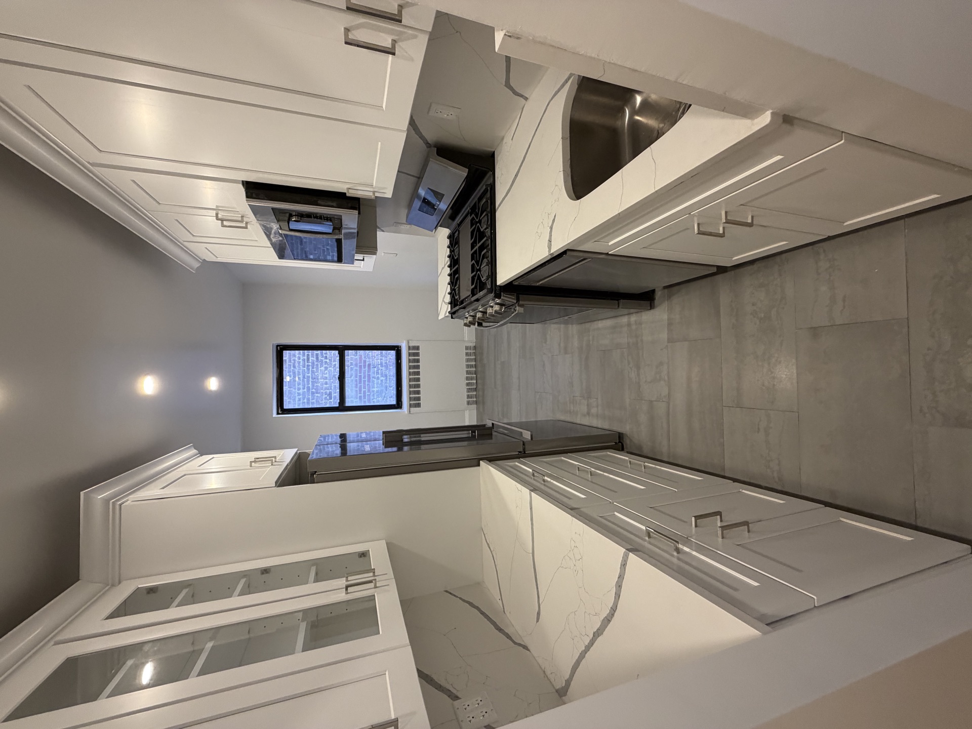 Modern white kitchen with quartz waterfall island